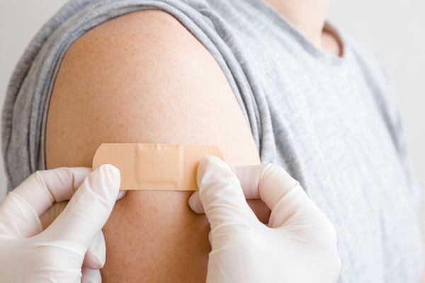 Close up of woman having a vaccination with a needle