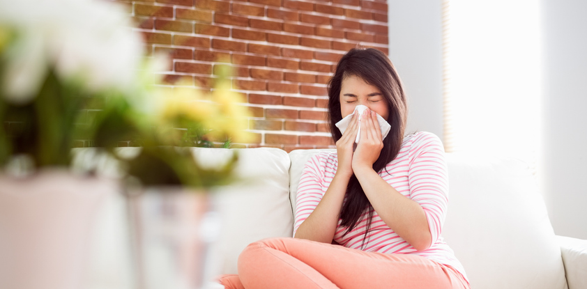 Woman blowing nose