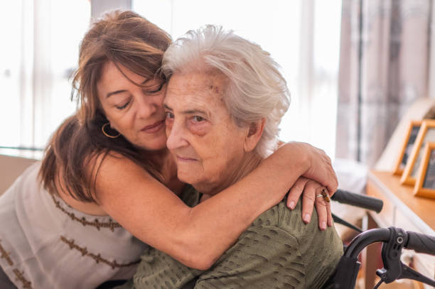 Woman hugging her elderly mother