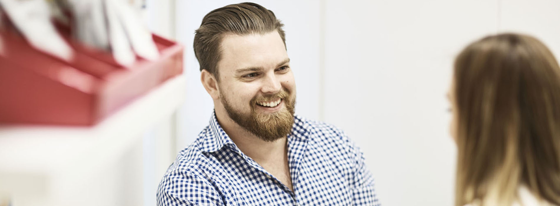 Smiling man speaking with a pharmacist