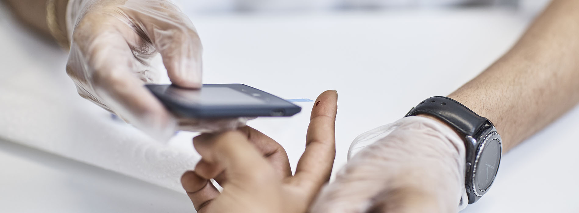 Close up of person receiving a diabetes blood prick test