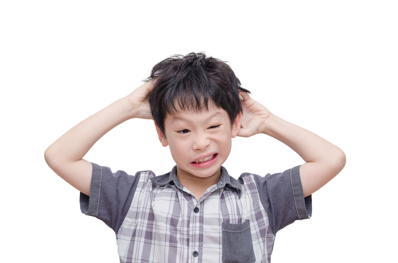 Young boy scratching in his hair and looking uncomfortable