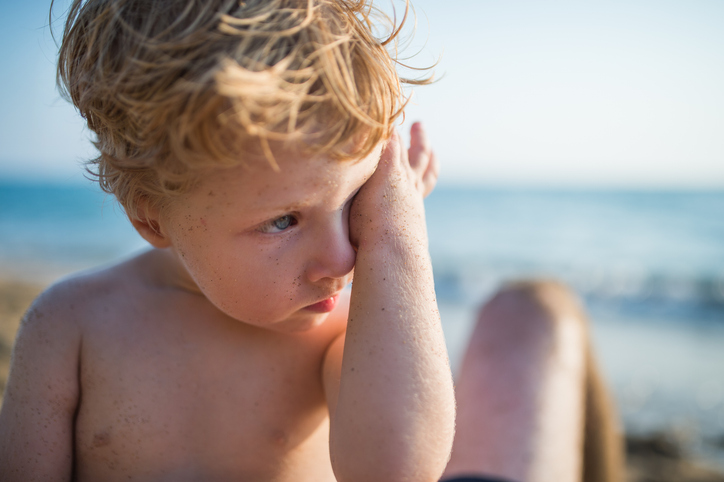 Child with sand in eyes