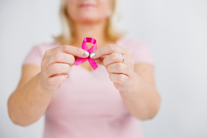 Woman holding Breast Cancer Awareness ribbon