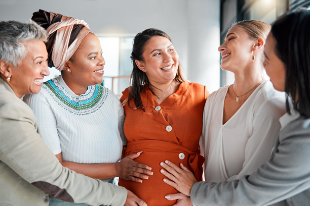 Pregnant woman, surrounded by support group